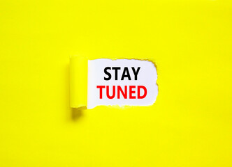 Stay tuned symbol. Concept words Stay tuned on beautiful white paper on a beautiful yellow background. Business, support, motivation, psychological and stay tuned concept. Copy space.