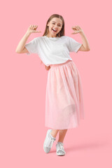 Young woman in t-shirt pointing at herself on pink background