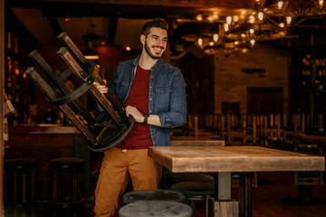 Cafe Owner standing in his Restaurant while Reopening, proud of his business