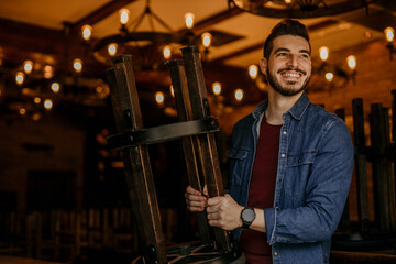 Cafe Owner standing in his Restaurant while Reopening, proud of his business