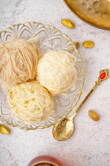 Bowl with tasty Turkish Pismaniye on light background