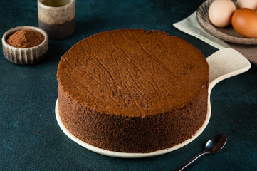 Homemade round chocolate sponge cake or chiffon cake. Sponge cake ingredients: eggs, flour and...