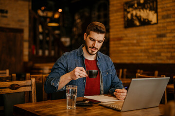 Shot of a young man looking thoughtful while having coffee at a cafe