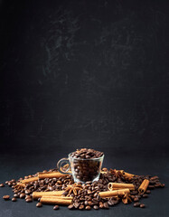 The concept of fragrant hot coffee with spices. Autumn, winter, cold season. Hot drinks. Coffee on a dark background.