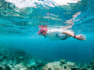 woman snorkeling in clear tropical sea