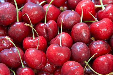 top view flat lay close up of fresh organic Bing Cherries with stems.