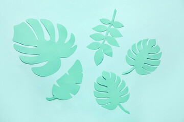 Different tropical leaves on pale turquoise background