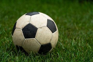 Fototapeta na wymiar Soccer ball in the green wet grass