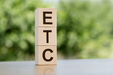 Light wooden blocks and cubes with the text ETC - short for electronic trade confirmation or et...