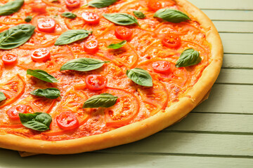 Tasty pizza margarita on green wooden background