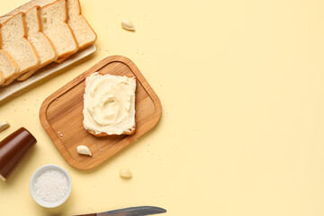Tasty toast with cream cheese on yellow background