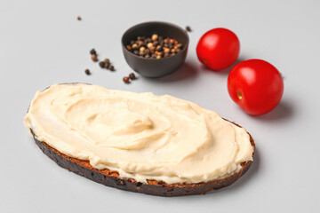 Tasty sandwich with cream cheese on grey background