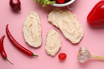 Tasty sandwiches with cream cheese on pink background