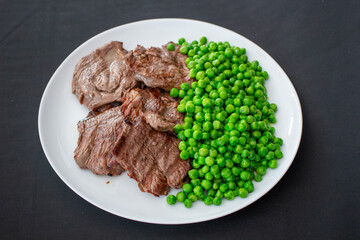 Dish made filet mignon with peas