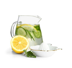 Jug of infused water with cucumber slices and juicer on white background