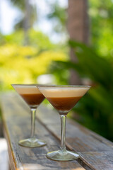 Two glasses of espresso martini at a beach bar in the Maldives