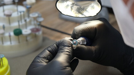 dentist preparing new tooth on dental mold