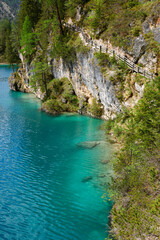 Fototapeta premium Landscape view of the emerald smooth surface of Lago di Braies in the Dolomites, northern Italy, Europe