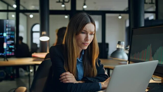 Upset finance manager look computer in evening office. Frustrated woman broker