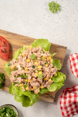 Sandwich with tuna, corn and tomato on wood