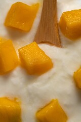 Delicious glass of cold yogurt mousse with mango.