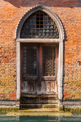 Fototapeta na wymiar Typical venetian style door and windows in Venice, Italy