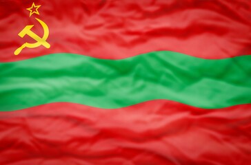 Transnistria flag on a wavy background. Wavy flag of Transnistria fills the frame.