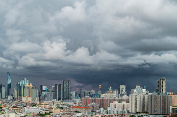 As the storm intensifies, lightning flashes across the sky, illuminating the dramatic clouds that seem to swirl and dance above the city center.