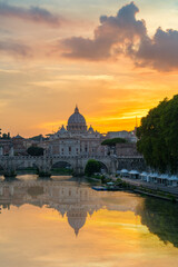 Fototapeta na wymiar St. Peter's basilica across Tiber River canal at sunset in Rome, Italy