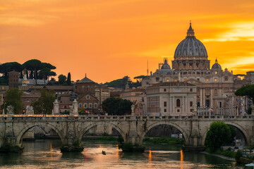 Fototapeta premium St. Peter's basilica across Tiber River canal at sunset in Rome, Italy
