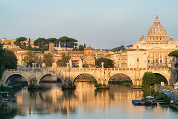 St. Peter's basilica and St. Angelo bridge at morning light in Vatican. Rome. Italy