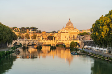 Fototapeta na wymiar St. Peter's basilica and St. Angelo bridge at morning light in Vatican. Rome. Italy
