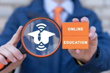 Man holding magnifier with icon of graduation cap and orange blocks with inscription: ONLINE...