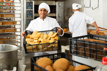 Fototapeta Portrait of successful baker during daily work in bakeshop obraz