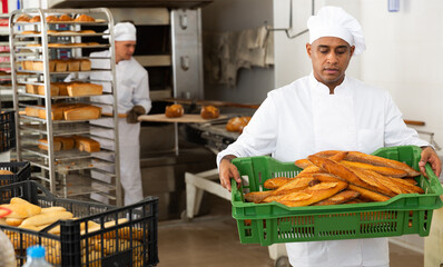 Fototapeta male baker with sesame bread in black box in kitchen obraz