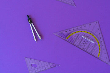 Fototapeta Fractions, rulers on violet background. Set of supplies for mathematics and for school. Back to school, fun education concept. Geometry background	 obraz