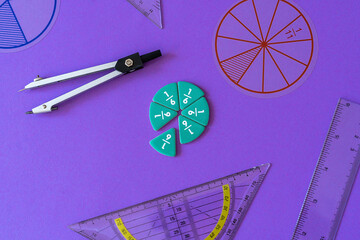 Fototapeta Fractions, rulers on violet background. Set of supplies for mathematics and for school. Back to school, fun education concept. Geometry background	 obraz