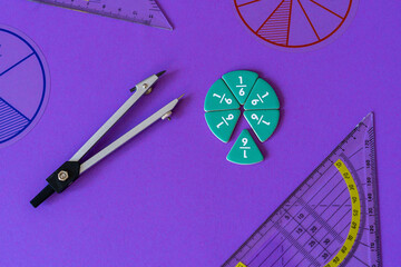 Fractions, rulers on violet background. Set of supplies for mathematics and for school. Back to...