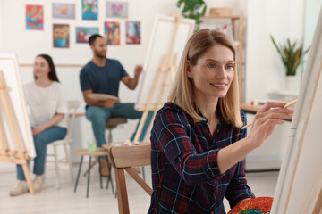 Group of students attending painting class in studio. Creative hobby