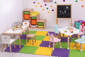 Stylish kindergarten interior with toys and modern furniture