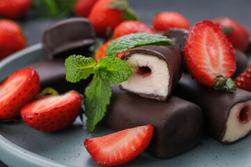 Delicious glazed curd snacks with fresh strawberries and mint, closeup