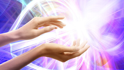 Aura phenomena. Woman with flows of energy around her hands against color background, closeup