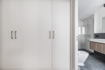 A dressing room with white wooden door