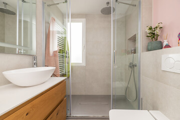 Bathroom with wooden furniture with designer sink,
