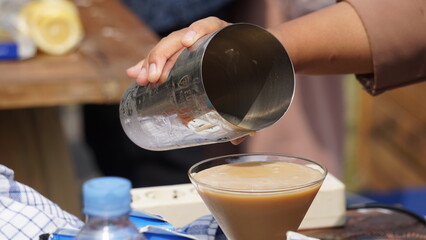 The barista is serving coffee for the customer