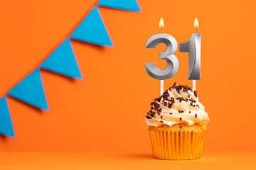 Birthday cake with candle number 31 - Orange background