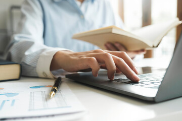 Close up female hands using computer laptop for online working.