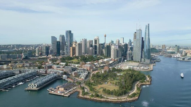 Aerial footage of awe-inspiring beauty of Sydney Harbour with breathtaking iconic ferry, landmarks, sparkling water, and vibrant cityscape with Darling Harbour in the background. Forward moving shot.