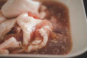 Marinated pork for making pan-fried pork in the buffet restaurant. Thai style grilled pork on pan or Mookata.