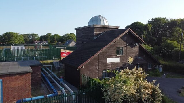Aerial view rising over Leighton observatory silver dome scientific astronomy building, Pex hill UK